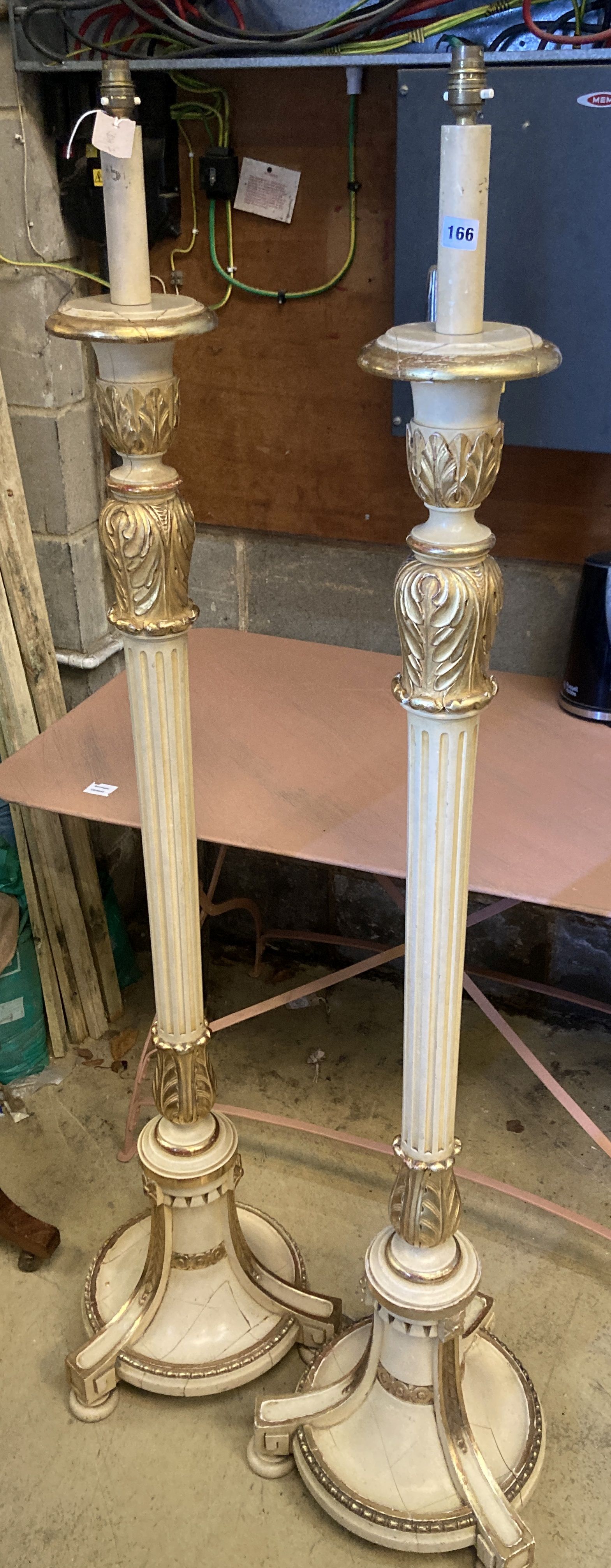 A pair of cream painted parcel gilt standard lamps, height 166cm